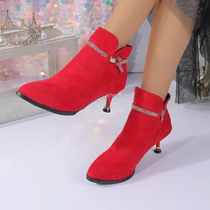 Red suede pointed toe kitten heel ankle boots with rhinestone detail on a model.