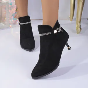 Chic black pointed-toe mid-heel ankle boots featuring a decorative rhinestone strap