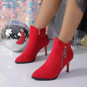 Elegant red pointed toe stiletto ankle boots with side zipper and suede finish.
