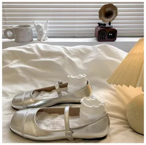 Detailed shot of silver girls' Mary Jane shoes with metallic finish and buckle strap