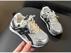 Close-up of children's silver breathable mesh sneakers with metallic finish and black accents