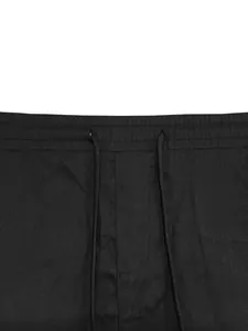 Detailed macro shot of men's cotton cargo shorts waistband with adjustable black drawstring.