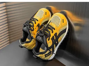 Detailed view of yellow and black mesh breathable chunky sneakers for boys and girls.