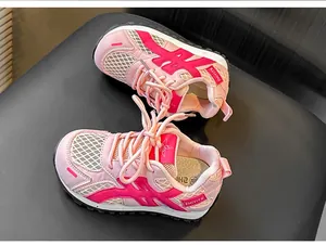Detail view of pink and white mesh breathable children's sneakers for autumn running