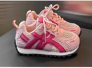 Close-up of pink children's sneakers featuring breathable mesh and durable soles