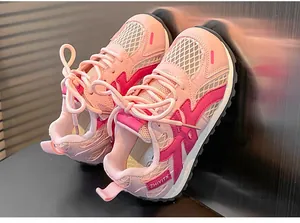 Detailed side view of pink breathable mesh kids sneakers with stylish side cross straps