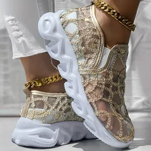 Detail view of breathable gold mesh slip-on platform sneakers for women with wavy soles.