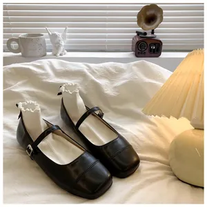 Detailed view of black Mary Jane girl's shoes paired with ruffled white socks
