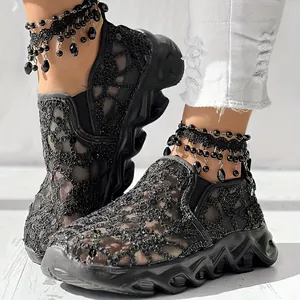 Close-up of black breathable mesh platform sneakers with sequined hollow-out details