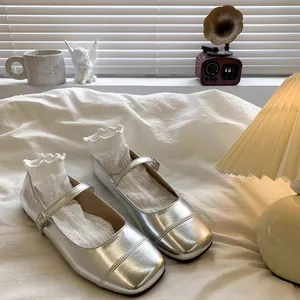 Elegant silver Mary Jane princess shoes for girls on cozy white bed with vintage decor.