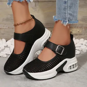 Detail shot of breathable mesh platform wedge sneakers with Mary Jane buckle strap on model