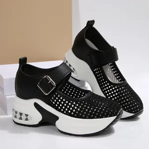 Detail view of breathable black mesh platform wedge sandals with adjustable buckles