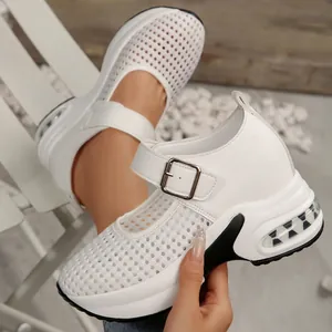 Macro detail showing breathable mesh upper of white wedge Mary Jane platform sneakers