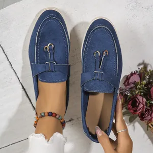 Deep blue women's suede flat loafers with soft sole and an elegant slip-on style.