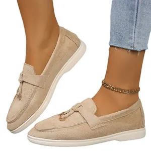 Comfortable beige suede flat loafers for women featuring a slip-on design and gold ring buckle
