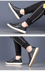 Detail view of black pebbled leather men's casual sneakers with white soles