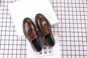 Detailed view of brown leather tassel loafers for men in a business casual style.