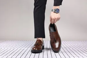 Detailed view of brown leather tassel loafers for men, business casual slip-on design.