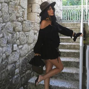 Model wearing a sexy black off-the-shoulder mini dress with elegant flared sleeves