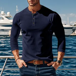 Detail view of navy blue ribbed Henley shirt for men styled with casual jeans outdoors.