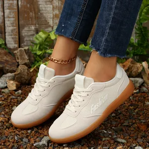 Detailansicht cremefarbener Retro-Sneaker aus Mesh mit Gummisohle und weißen Schnürsenkeln