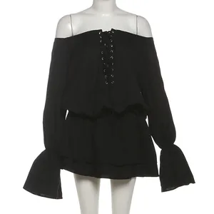Detail view of black off-the-shoulder dress with lace-up front and flared bell sleeves