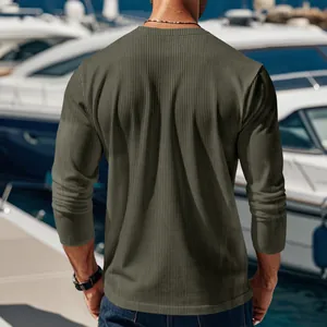 Back view detail of men's olive green ribbed corduroy long sleeve shirt in outdoor setting