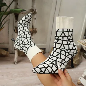High stiletto heel pointed toe sock boots with black and white geometric pattern