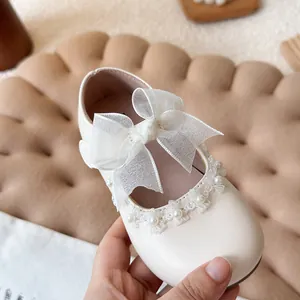 White girl's Mary Jane princess shoes with elegant organza bow and pearl lace trim