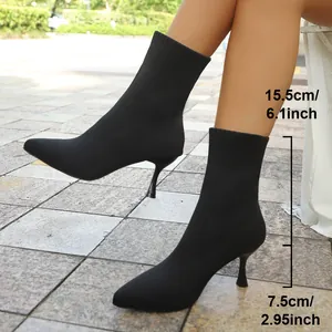 Black pointed-toe stretchy fabric stiletto sock boots showing heel and shaft height