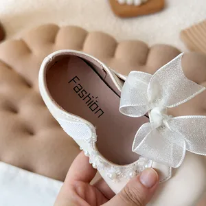 Elegant white princess shoes for girls featuring a soft sole, mesh bow and pearls