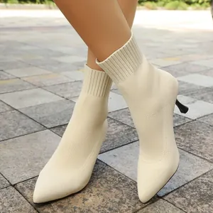 Detailed view of women's beige pointed toe knitted sock boots with slim stiletto heels