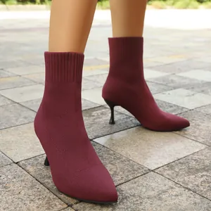 Close-up of wine red pointed-toe stretch fabric ankle boots with stiletto heel