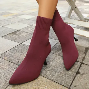 Elegant burgundy pointed-toe stretch fabric sock boots with slim high heels outdoor view