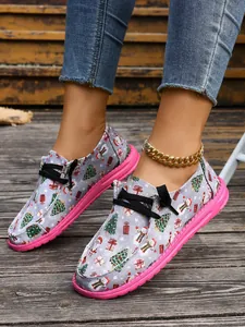 Close-up detail of festive Christmas pattern canvas shoes with bright pink soles
