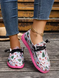 Festive Christmas themed canvas slip-on flats with colorful Santa and tree prints