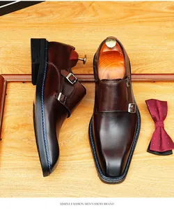 Close-up detail of brown leather square toe monk strap shoes with stylish double buckles