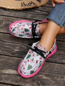 Close-up of women's Christmas print canvas loafers on a wooden floor.