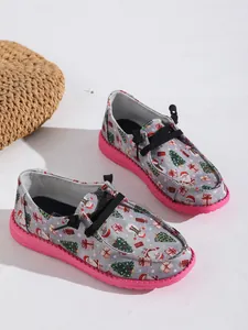 Christmas-themed low-top canvas loafers with pink soles and festive holiday prints