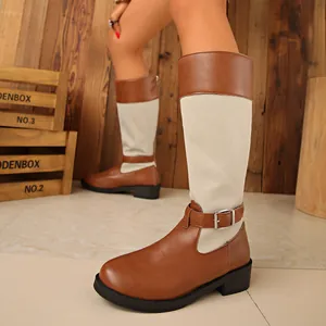 Detailed view of women's two-tone knight boots featuring denim patchwork and a decorative metal buckle