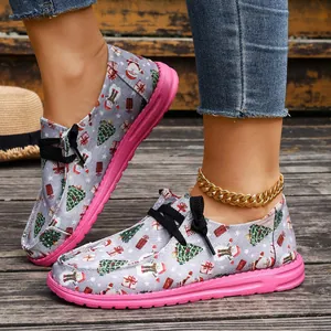 Festive women's low-top Christmas print canvas shoes featuring pink soles and black laces.