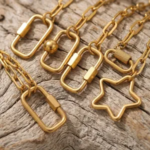 Close-up of gold stainless steel paperclip necklaces with geometric carabiner star clasps.