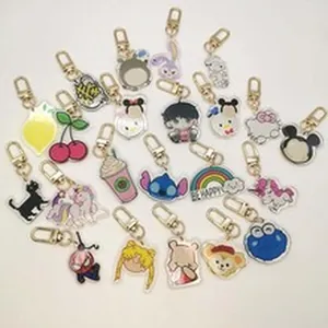 Collection of various cartoon acrylic keychains with characters and symbols