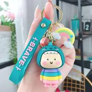Close-up of a cute cartoon doll keychain with rainbow charm and blue brave strap