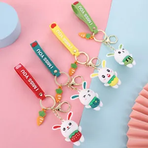 Four colorful cartoon rabbit keychains featuring carrot charms and 'I MISS YOU' straps