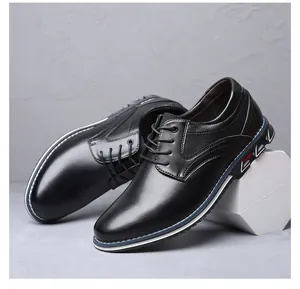 Close-up of black business leather shoes with textured panels and lace-up design