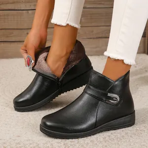 Primer plano de botines de cuero negro con forro de felpa cálido para mujeres mayores