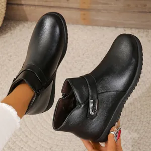 Detalle de botines de cuero negro con un cálido forro de felpa marrón para el invierno