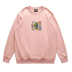 Pink crewneck sweatshirt with sunflower and inspirational God Says You Are text