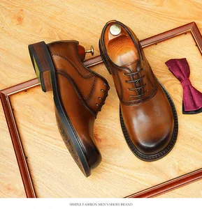 High-quality macro view of handmade brown leather oxfords featuring vintage brogue accents.